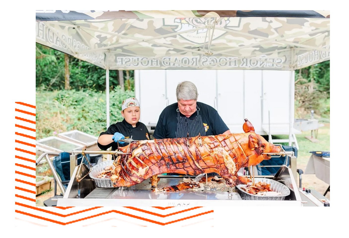 A man and woman standing next to a large meat.